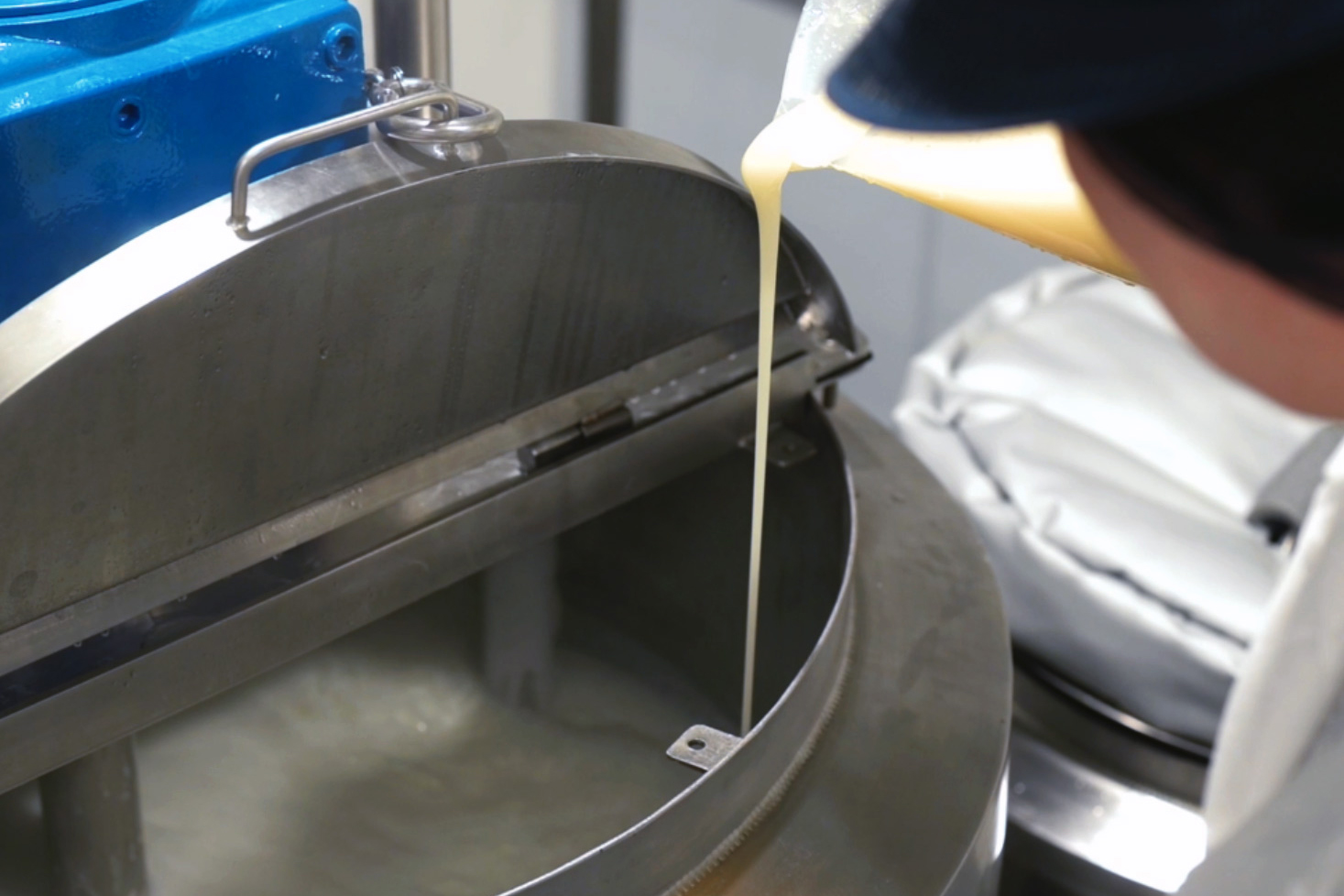 pouring product into machinery at Natural Skincare Solutions