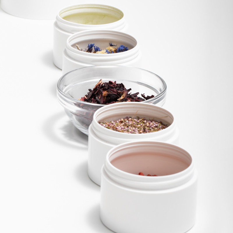 Row of ingredients in white label containers