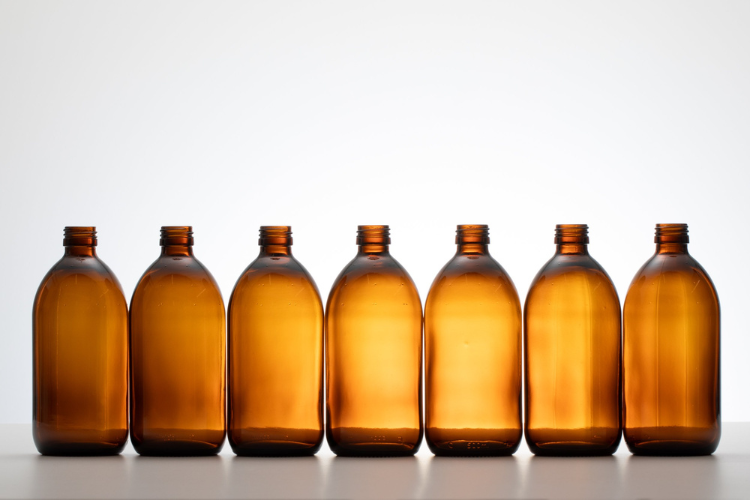 row of brown glass bottles filled with shower gel