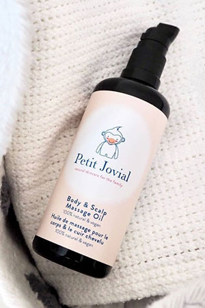 Bottle of petit jovial body and scalp massage oil