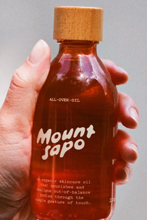 Orange bottle filled with Mount Sapo all over oil